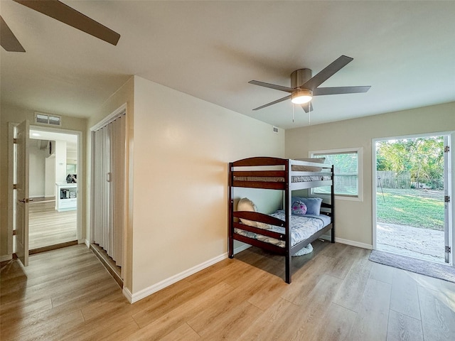 bedroom with access to outside, light hardwood / wood-style floors, and ceiling fan