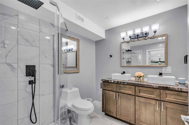 bathroom featuring vanity, toilet, and a shower with shower door