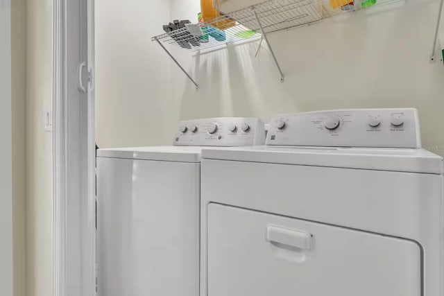 clothes washing area with washing machine and dryer