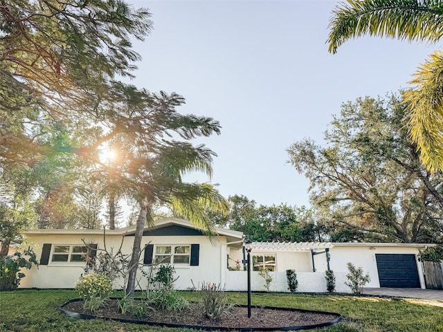 view of front of house featuring a front yard and a garage