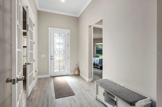 foyer with crown molding, french doors, and light wood-type flooring