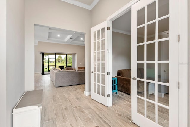 hall with coffered ceiling, french doors, ornamental molding, beam ceiling, and light hardwood / wood-style floors