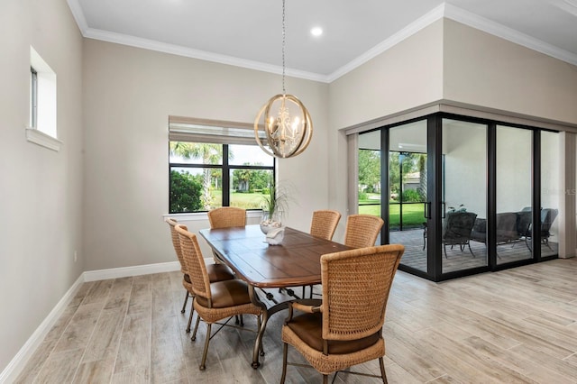 dining room featuring light wood-type flooring, a wealth of natural light, and crown molding