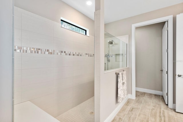 bathroom featuring hardwood / wood-style floors and tiled shower