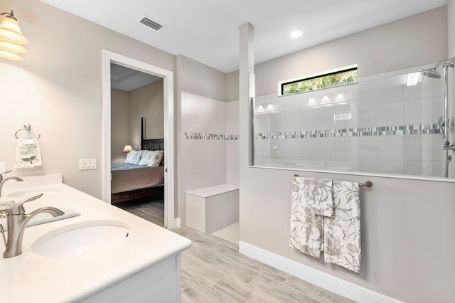 bathroom with vanity and a tile shower