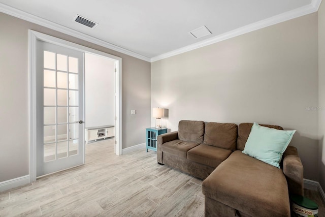 living room featuring crown molding and light hardwood / wood-style flooring