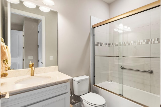 full bathroom with vanity, enclosed tub / shower combo, and toilet