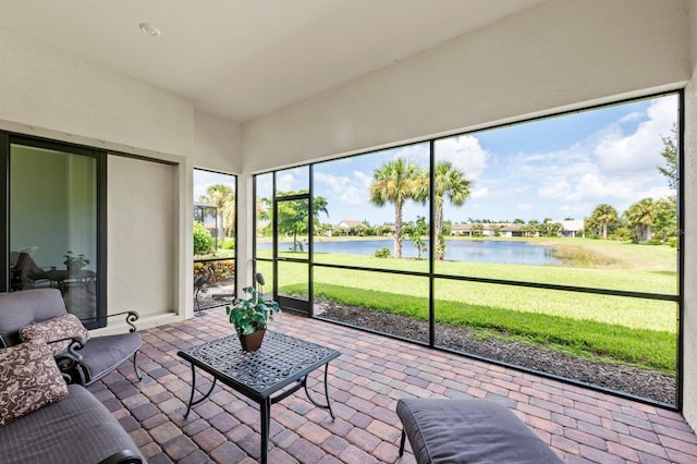 sunroom / solarium featuring a water view