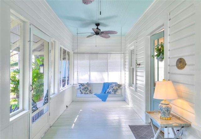 sunroom featuring ceiling fan