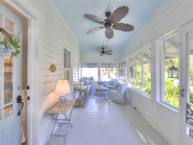 sunroom / solarium featuring ceiling fan and lofted ceiling