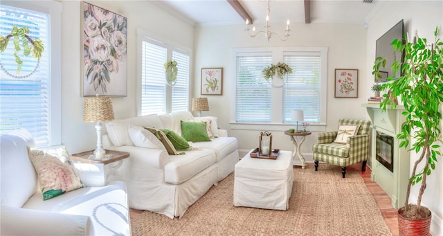 sitting room featuring beam ceiling, light hardwood / wood-style flooring, an inviting chandelier, and ornamental molding