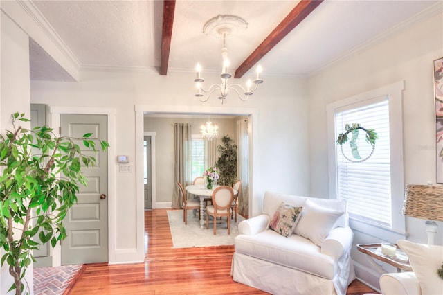 interior space with beamed ceiling, a notable chandelier, light hardwood / wood-style floors, and crown molding