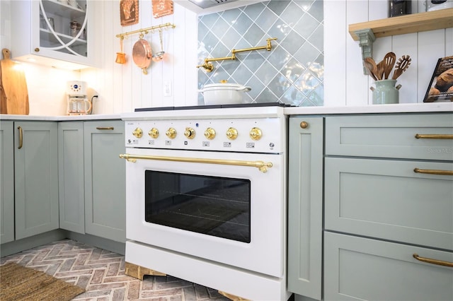 kitchen featuring decorative backsplash and white range