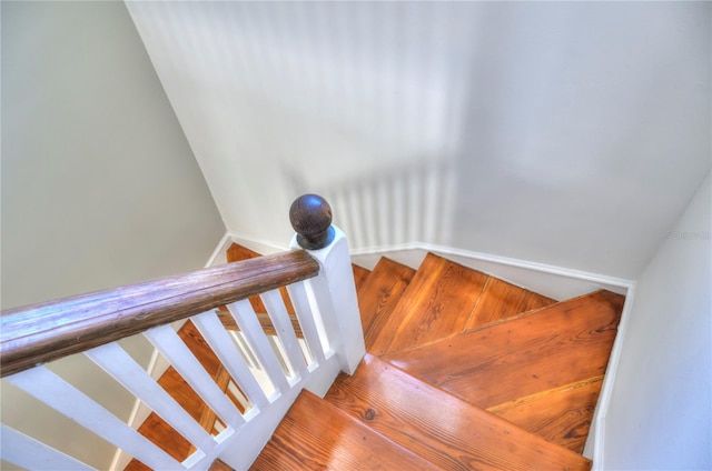 stairs featuring hardwood / wood-style floors