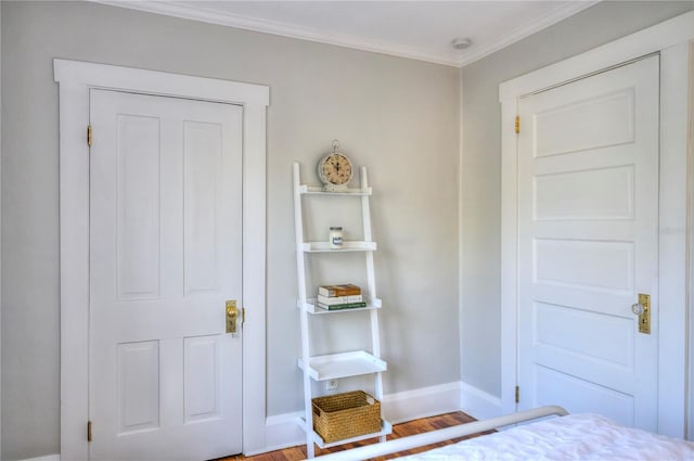 unfurnished bedroom with wood-type flooring and crown molding