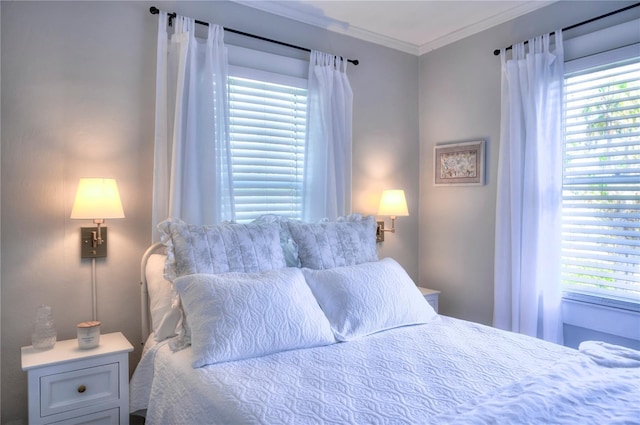 bedroom featuring multiple windows and ornamental molding