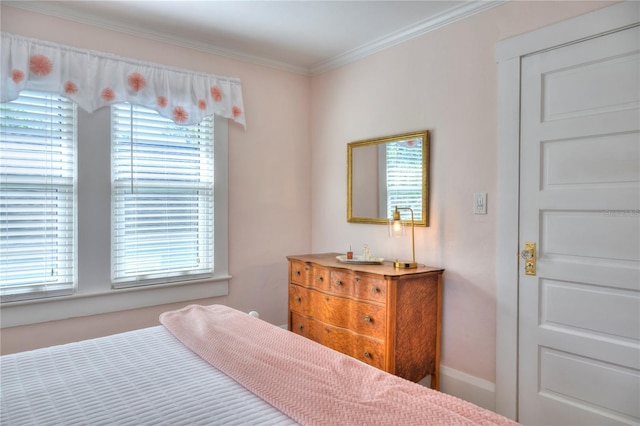 bedroom featuring carpet, ornamental molding, and multiple windows