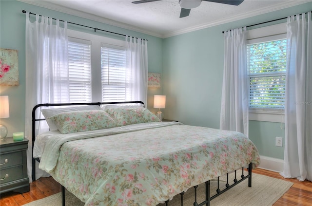 bedroom featuring ceiling fan, light hardwood / wood-style flooring, crown molding, and a textured ceiling