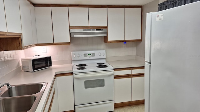 kitchen featuring backsplash, sink, white cabinets, and white appliances