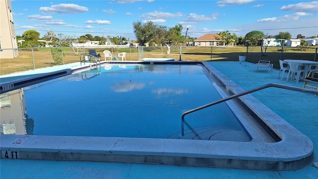 view of pool featuring a yard