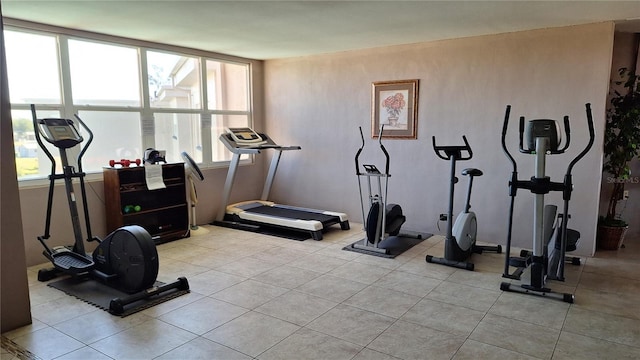 workout room featuring light tile patterned flooring