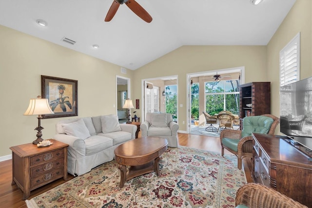 living room featuring light hardwood / wood-style flooring and vaulted ceiling