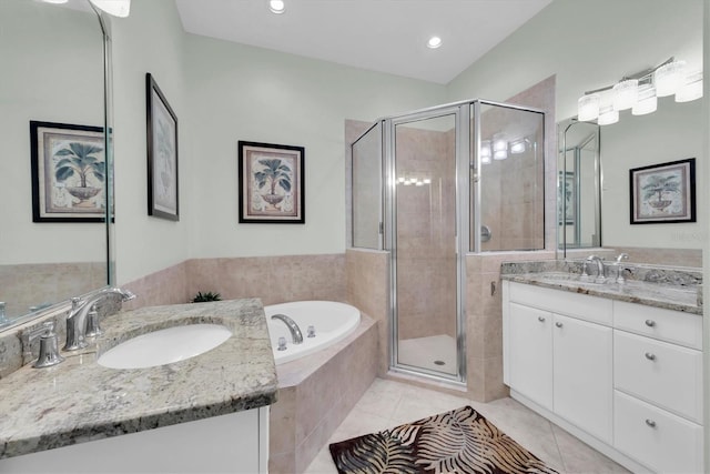 bathroom featuring shower with separate bathtub, vanity, and tile patterned floors