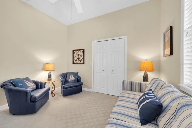 carpeted living room with ceiling fan