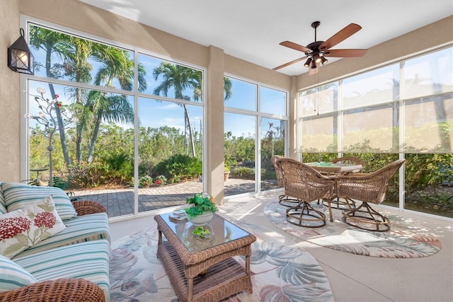 sunroom / solarium featuring ceiling fan