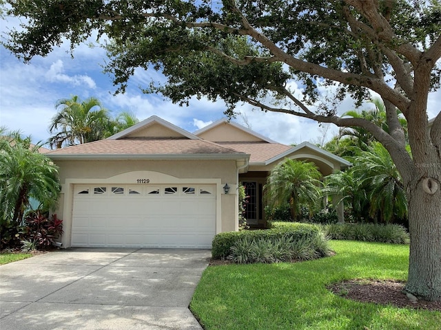 single story home with a garage and a front yard