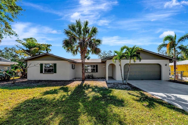 single story home featuring a garage and a front lawn