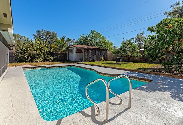 view of swimming pool with a shed and a patio