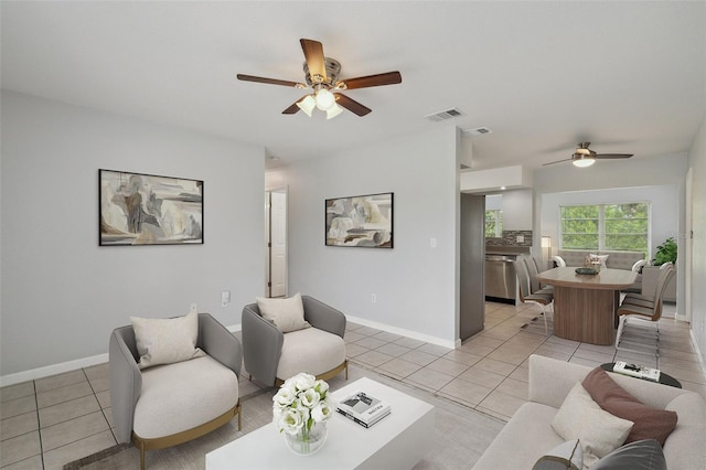 living room with ceiling fan and light tile patterned floors