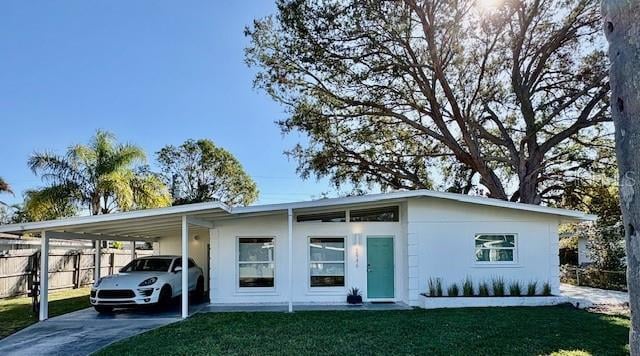 view of front of property with a carport and a front yard