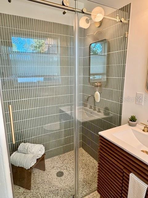 bathroom featuring vanity and a shower with shower door