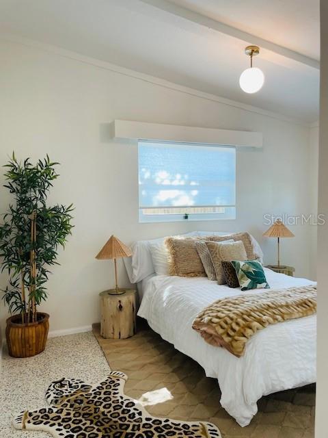 bedroom with lofted ceiling with beams