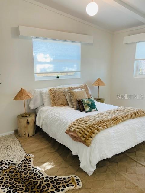 bedroom featuring vaulted ceiling with beams