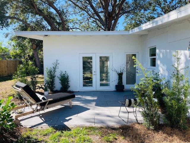 rear view of property with french doors and a patio