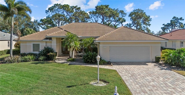 ranch-style house featuring a garage and a front yard