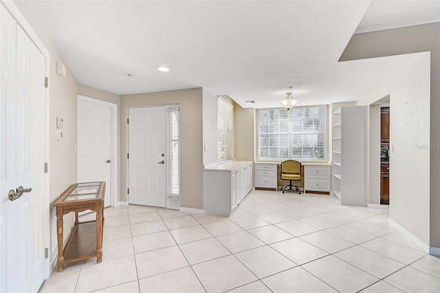 tiled entrance foyer with a textured ceiling