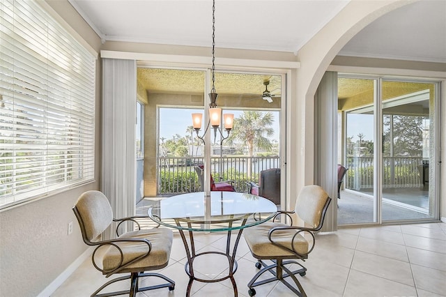 dining room featuring light tile patterned flooring, a water view, crown molding, and a chandelier