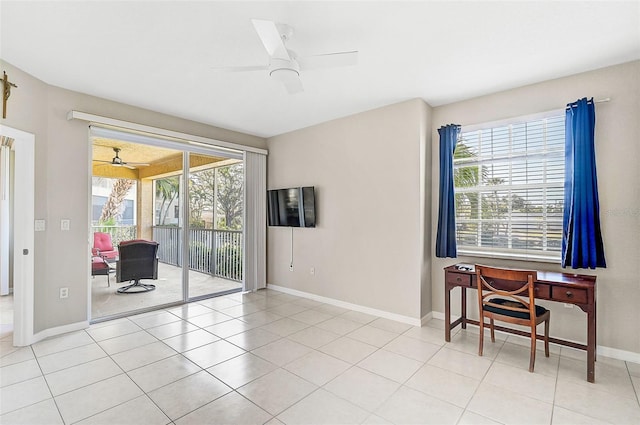 empty room featuring plenty of natural light, ceiling fan, and light tile patterned floors