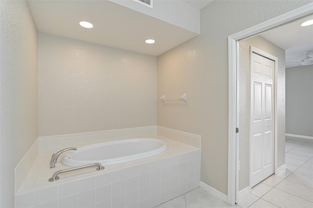 bathroom with tile patterned floors and tiled bath