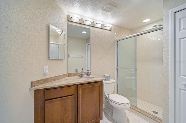 bathroom with vanity, a textured ceiling, toilet, and walk in shower