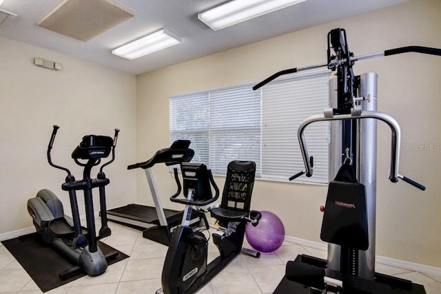 exercise room with light tile patterned floors