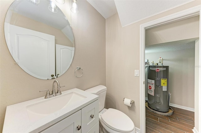 bathroom with vanity, toilet, a textured ceiling, and water heater