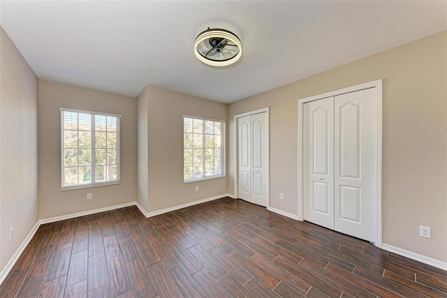 unfurnished bedroom with two closets