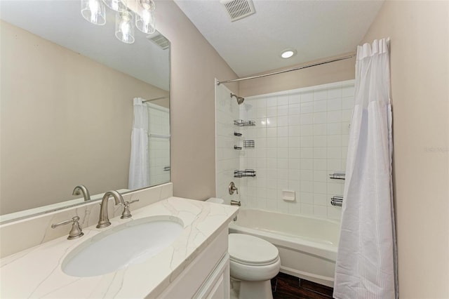 full bathroom featuring shower / bath combo, vanity, a textured ceiling, wood-type flooring, and toilet