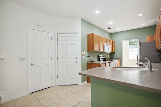 kitchen featuring sink, light tile patterned floors, and appliances with stainless steel finishes