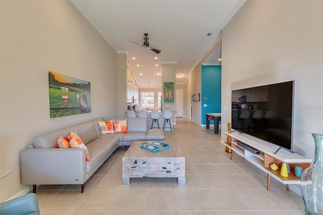 living room with crown molding, light tile patterned floors, and ceiling fan